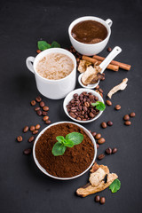 Mushroom Chaga Coffee Superfood Trend-dry and fresh mushrooms and coffee beans on dark background with mint.