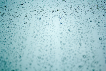 Raindrops on the glass. Blue and gray sky.