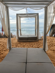 Fototapeta na wymiar Beautiful image of sunbeds with canopy on the ocean beach