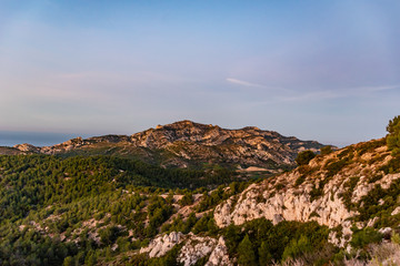 Sunrise at Calanque de Morgiou (Marseille, France): the breathtaking cliff mountain landscape under the warm soft  sunlight