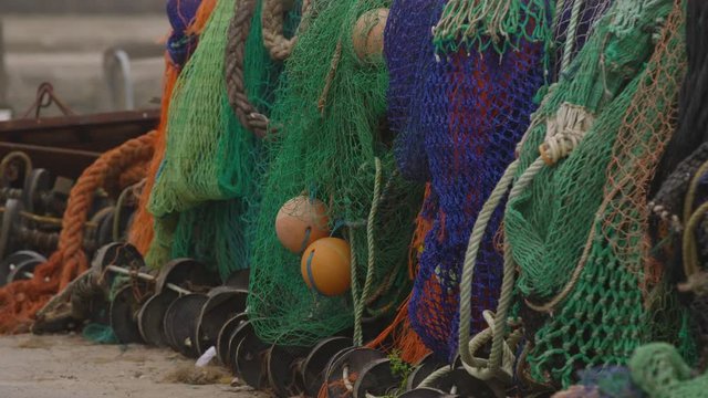 Close up of several fishing nets hanging in a row for storage