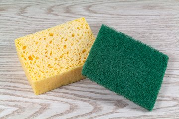 Yellow synthetic sponge and green scrub pad