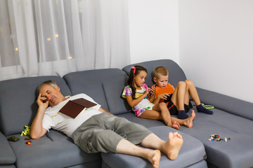 children play with your smartphone while grandfather is sleeping