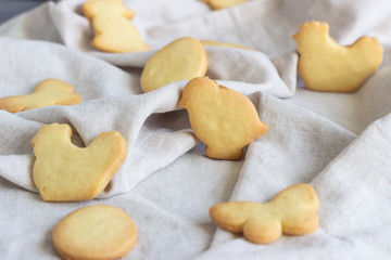 Fototapeta na wymiar Easter cookies on a grey linen napkin. Homemade butter and sugar cookies.