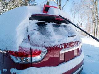 cleaning the car after the snow storm