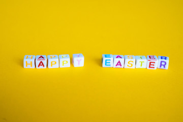 Easter greeting card with painted eggs. Seasonal Easter message  "Happy easter". Pastel and colorful   decorated easter eggs with greeting card with text on yellow background. Spring holidays concept.