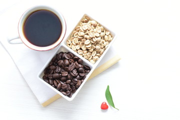 Traditional cup of Colombian coffee with coffee beans on wooden background