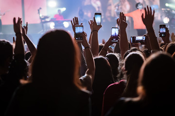 People having fun with their hands in the sky at the live music concert