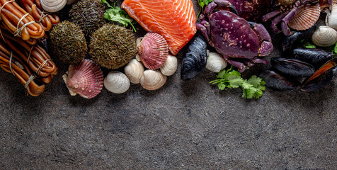 PACIFIC SEAFOOD. Fresh salmon, crabs ostions clams mussels, seaweed cochayuyo, sea urchins. Food background with copy space