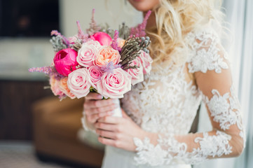 Bride holding her wedding bouquet. Unusual wedding stylish bouquet with magenta and pink flowers