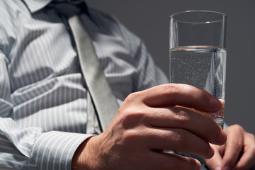 businessman with a glass of water, hands close view
