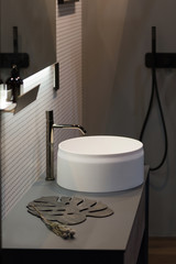 Bathroom design, round freestanding washbasin in a dark elegant bathroom