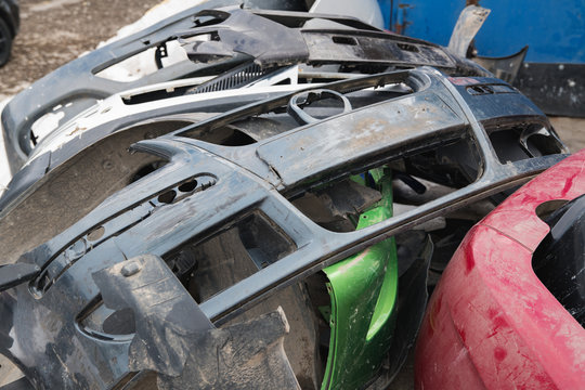 broken plastic bumpers of cars for recycling during the day