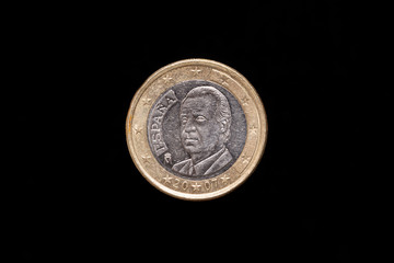 Spanish 1 Euro coin from 2007, obverse showing portrait of King Juan Carlos I. Isolated on black background
