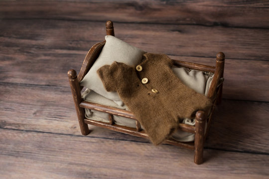 a baby cot and a costume for a newborn photo shoot. props for a photo shoot.