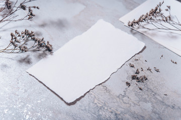 Wedding invitation mockup with dry plants , papers on stone background. Top view, flat lay. Wedding stationary. Perfect for presentation of your invitation, menu, greeting cards. Winter concept