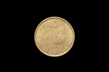 Spanish 50 Euro Cent coin from 2017, obverse showing portrait of Miguel de Cervantes. Isolated on black background