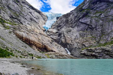 The Briksdalsbreen (Briksdal) glacier, which is the sleeve of the large Jostedalsbreen glacier in Norway. The melting glacier forms the Briksdalsbrevatnet lake with clear water.