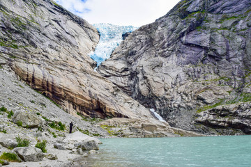 The Briksdalsbreen (Briksdal) glacier, which is the sleeve of the large Jostedalsbreen glacier in Norway. The melting glacier forms the Briksdalsbrevatnet lake with clear water.