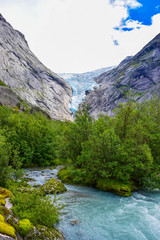 The Briksdalsbreen (Briksdal) glacier, which is the sleeve of the large Jostedalsbreen glacier in Norway. The melting glacier forms the Briksdalsbrevatnet lake with clear water.