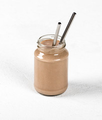 Milk chocolate cocktail with ice cream in a jar on a light background