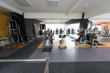 Fototapeta na wymiar Modern Gym Interior With Equipment