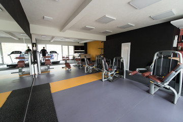 Fototapeta na wymiar Interior Of New Modern Gym With Equipment