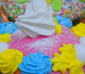 Bright delicious tasty pastries with multi-colored cream and mastic