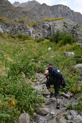 Mazeri region, Svaneti, Georgia - September 29, 2019: Tourist is hiking to Mazeri Waterfall