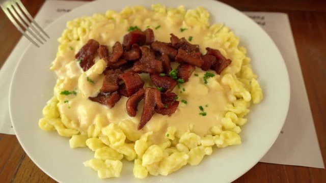 Spatzle with cheese and beef jerky, traditional Swiss dish prepared in Pozuzo, Peru