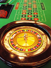 Roulette wheel green table inside a casino