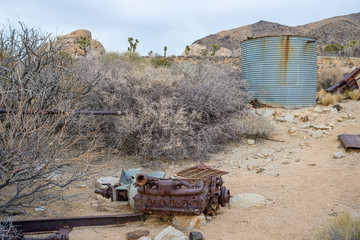 USA, California, San Bernardino County, Joshua Tree National Park. An  abandoned, rusty straight-six engine block and water tank near Ryan Ranch.