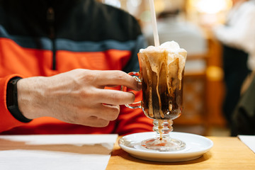 Man holding glass of coffee on a table
