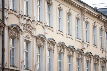 Typical Austro-Hungarian Facade of a baroque appartment residential building in a street of old town, the historical center of Prague, Czech Republic, in the most touristic part of the city.