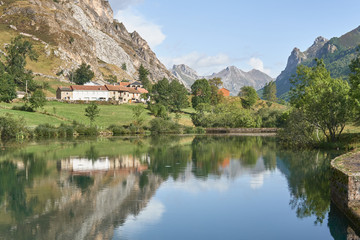 Fototapeta na wymiar A mountain houses reflected in a lake in Somiedo (Asturias, Spain)