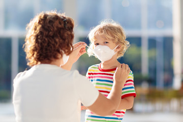 Mother and child with face mask and hand sanitizer