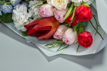 Beautiful summer bouquet in bright colors, gray backdrop, selective focus