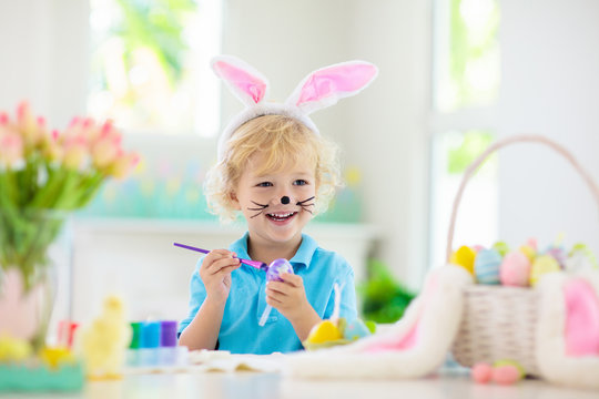 Kids on Easter egg hunt. Children dye eggs.