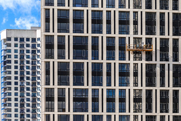 Obraz premium Modern high-rise buildings opposite a clear blue sky in perspective. The concept of urban development.