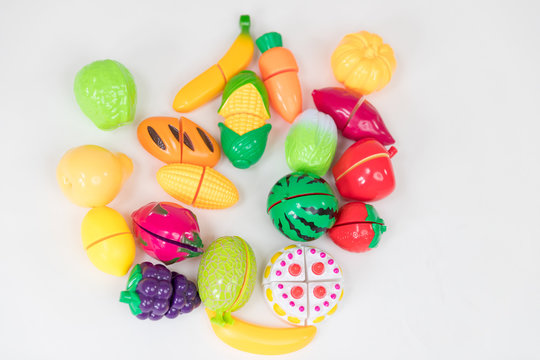still life image of plastic kids fruit and vegetable toys