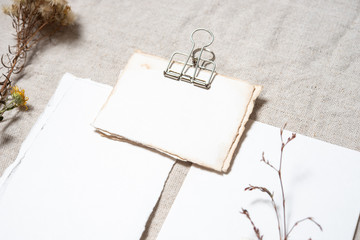 Wedding invitation mockup with dry plants , papers on textile background. Top view, flat lay. Wedding stationary. Perfect for presentation of your invitation, menu, greeting cards. Herbarium concept