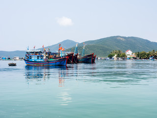 Fishing boats off the coast at Ben Tau Dam Mon pier, entry point for Whale Island - Van Ninh, Vietnam