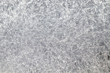 Texture of frozen ice in nature close-up as background