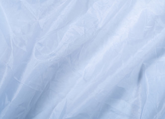 Blue clean sheet, close up view. Smooth blue textile, an abstract background. Texture of blue fabric. Background for wallpapers and banners