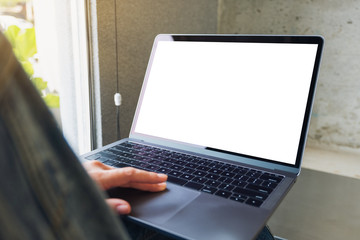 Mockup image of a woman using and touching on laptop computer touchpad with blank white desktop screen