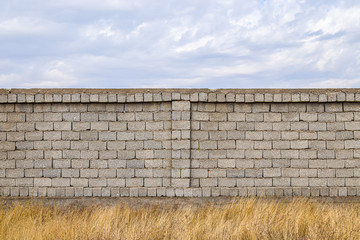 Cinder block fence against the sky