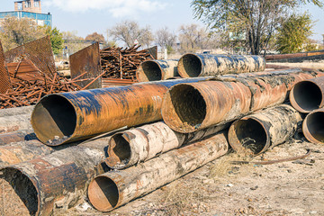 Old rusty metal pipes of large diameter scrap metal