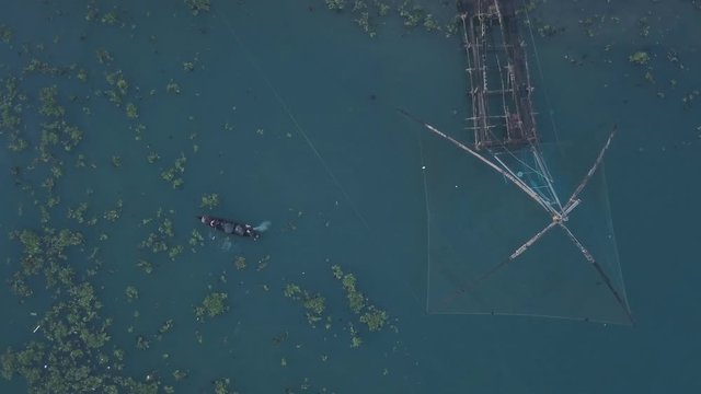 Traditional Chinese fishing nets and fishing boat at Fort Kochi, India. Top down aerial drone view