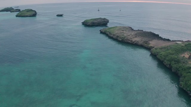 Fishing boats in Watamu Bay Beach at sunrise near Malindi, Kenya. Aerial drone reveal