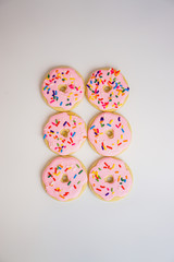 Pink sugar cookies decorated like donuts